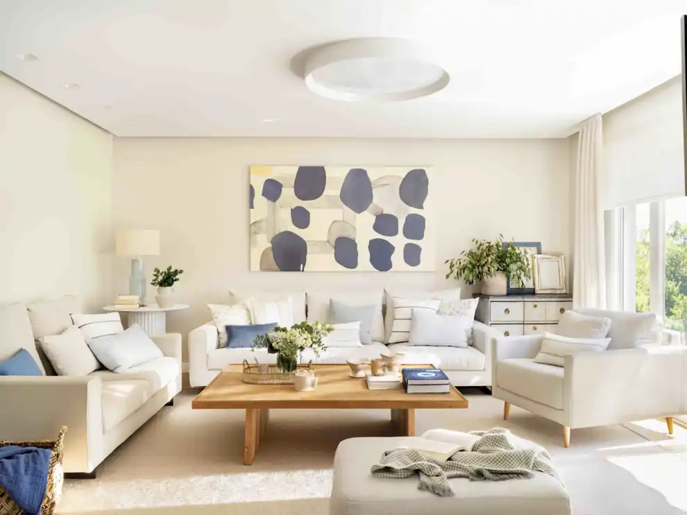 Salón con sofás blancos y mesa de centro de madera 00544923
